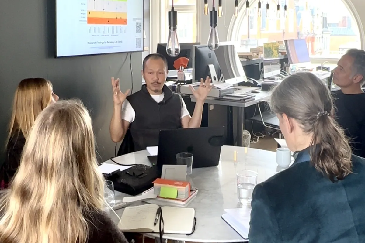 Interactive workshop discussion at SYTE architecture office with team around conference table