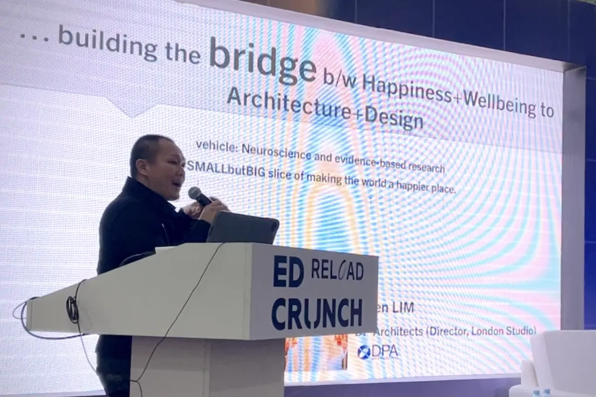 Frven speaking at Education Forum Kazakhstan 2022 about building bridges between happiness, wellbeing and architecture design