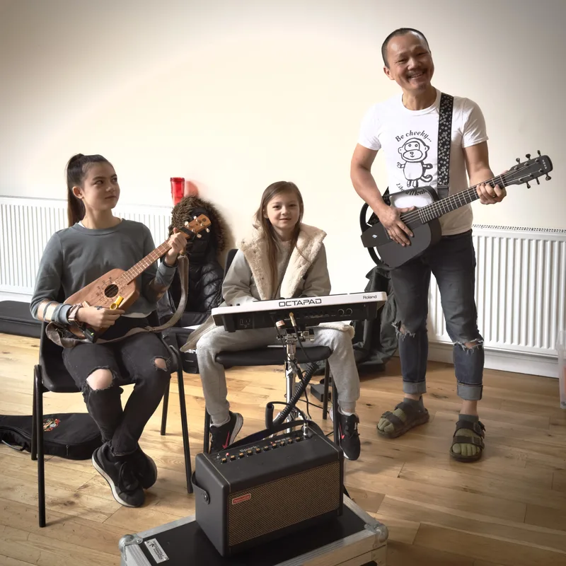 Children and adult making music together