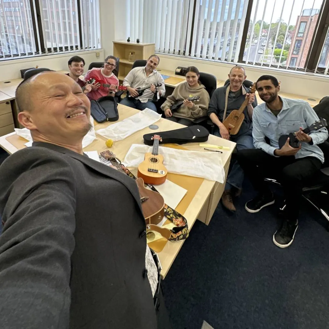 Frven Lim with the Balance Books team playing ukulele during Happier Music Workshop April 2026