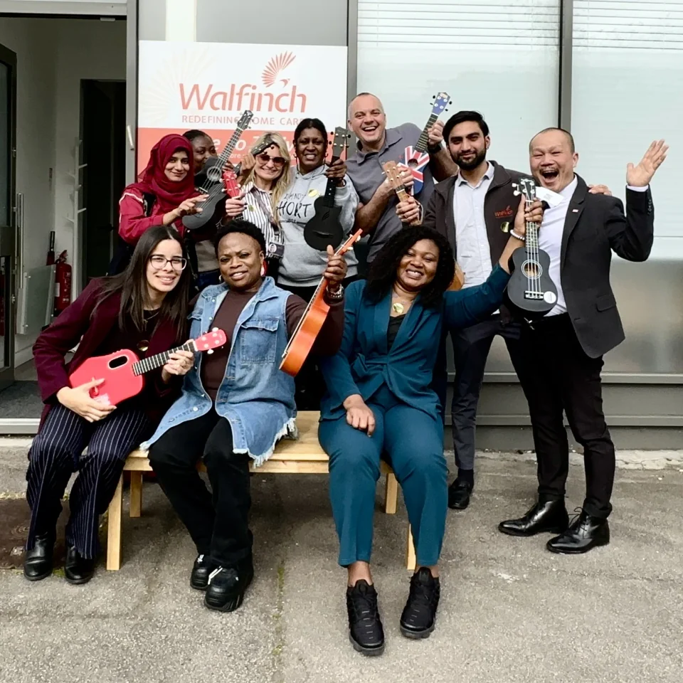 Walfinch team happily holding ukuleles after Happier Music Workshop April 2026